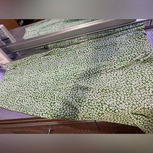 Green long skirt with white flowers.